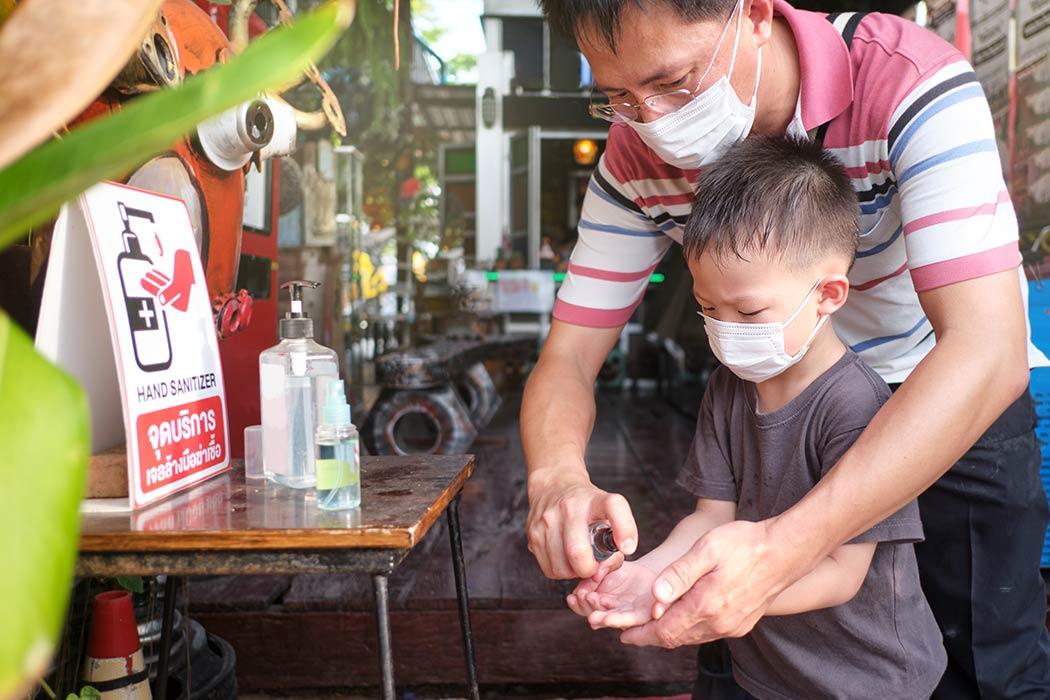 Father washing child's hand Father washing child's hand